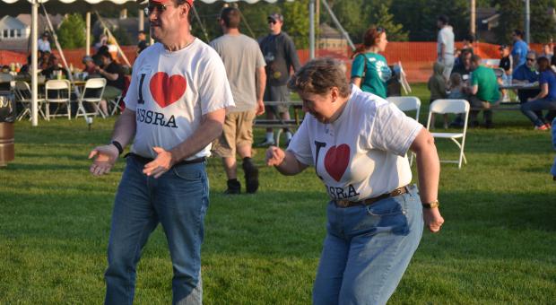 Sean Breen (left), of Glenview, and Karen Roscher, of Highwood, show off their dance moves at the fifth annual NSSRA Summer Bash on Aug. 13 in Northbrook.
